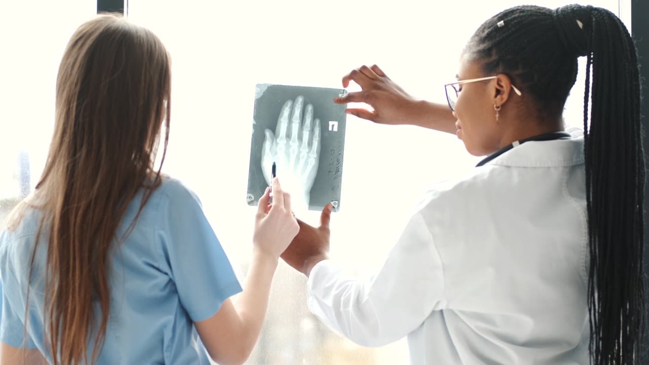 Healthcare professionals reviewing an X-ray; illustrative stock footage